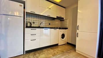 Presidential Apartment | Private kitchen | Full-size fridge, stovetop, cookware/dishes/utensils, dining tables