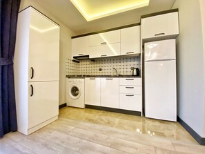 Full-sized fridge, stovetop, cookware/dishes/utensils, dining tables - My House Suite (Trabzon)