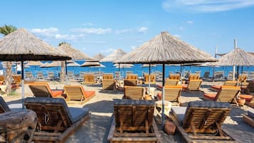 Playa privada, camastros, sombrillas y bar en la playa