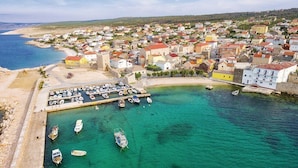 A coastal town with a marina, houses, and a beach. - Apartments Tara (Razanac)