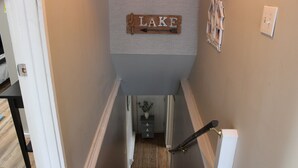 A hallway with a wooden sign that reads "LAKE" and an arrow pointing to the right.