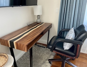 Relax in a well-organized space with a sleek desk, comfortable office chair, and cozy rug.