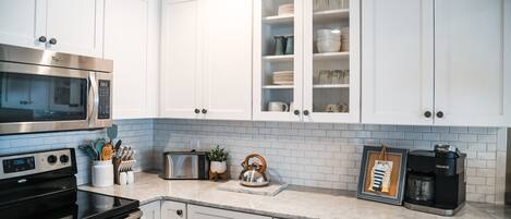 Electric stove and microwave with small appliances (toaster, coffee pot, kettle)