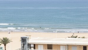 A beach view with a building in the foreground.