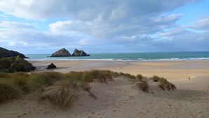 A beach with sand dunes and rocky formations in the background. - Twilight Lodge & Hot Tub (2 Bd rm) 2.5 miles to beach, peaceful setting. (Truro)