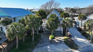 A residential area with houses, palm trees, and a clear sky. - Large Deck/ in-law suite /Walk to Beach/ Location! (Panama City Beach)