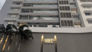 A high-rise building with a modern design, featuring balconies and a prominent entrance sign. - Polanco Residences Ambar Roca Santa Marta - Colombia (Santa Marta)