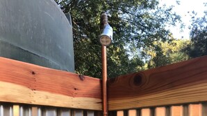 A metal fence with a wooden post and a metal pipe. - Sequoia Dawn  (Three Rivers)
