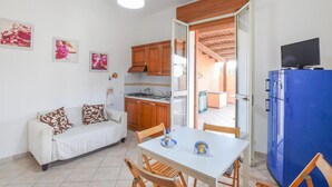 A compact kitchen with wooden cabinets, a white countertop, and a blue refrigerator. - Stunning home in Marina di Modica with WiFi (Marina di Modica)