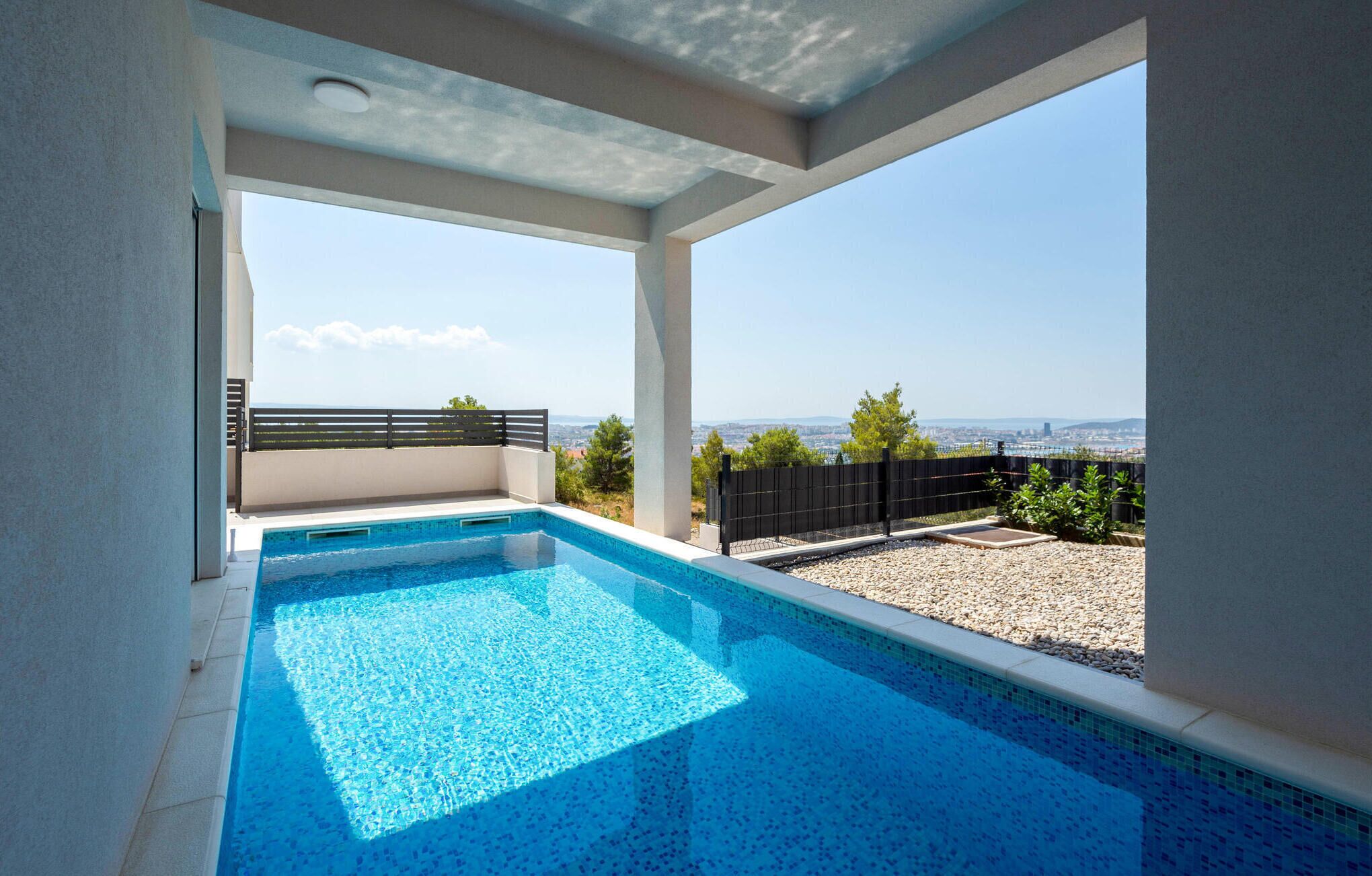 A swimming pool with a clear view of the cityscape in the background.