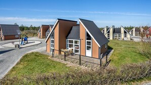 A modern residential building with a sloped roof, large windows, and a fenced yard. - Gorgeous home in Hadsund with WiFi (Hadsund)