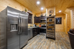 Enjoy cooking in this well-equipped kitchen with a refrigerator, oven, and ample storage.