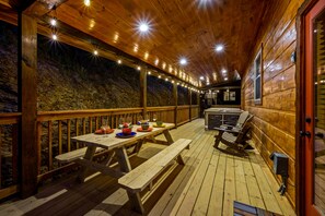 Enjoy al fresco dining on the cabin's outdoor deck, complete with a picnic table and grill station.