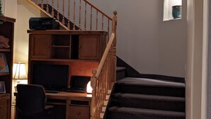 A multi-level home interior with a staircase, a desk with a computer, and a bookshelf. - #1 Large sunny room perfect for relaxing (St. George)