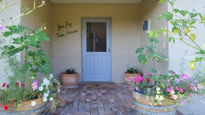A front door with a sign reading "Yea Fling Tree House" and potted plants with flowers on either side. - Yea Fig Tree House. Three bedroom plus study comfortable family home. (Yea)