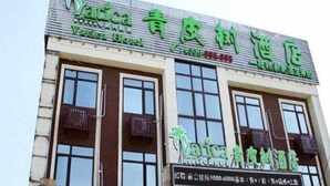 A building with signage for a hotel and a restaurant. - Vatica Chaoyang the East of Railway Station Xinhua Road Hotel (Chaoyang)