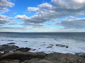 A coastal landscape with rocky shores and the ocean.