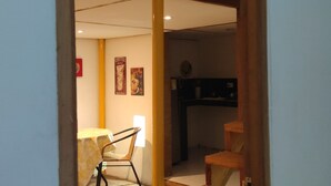 A staircase leading to a lofted sleeping area with a bed.