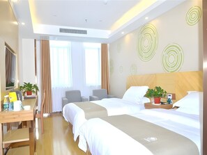 A hotel room with two beds, a desk, a chair, and a large window with curtains. - Greentree Inn Chizhou Dongzhi County Lishan Xiushui Express Hotel (Chizhou)