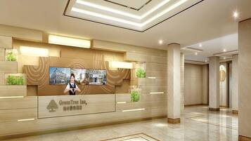 A hotel reception area with a modern design, featuring a reception desk, a large digital screen displaying a cityscape, and a clean, tiled floor.
