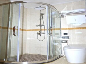 A glass-enclosed shower stall with a handheld showerhead, a toilet, and a towel rack. - Greentree Inn Chizhou Dongzhi County Lishan Xiushui Express Hotel (Chizhou)
