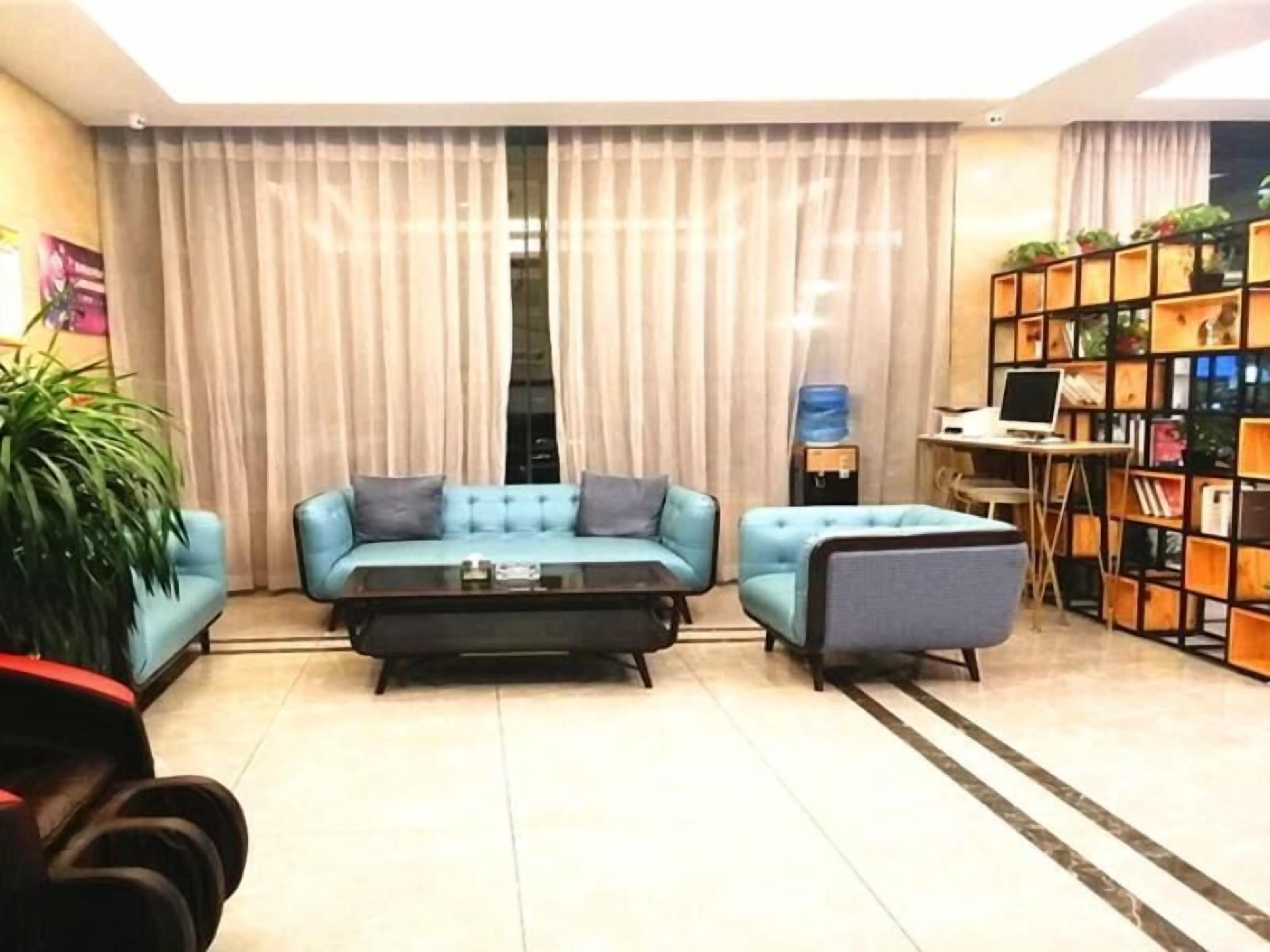 A living room with a sofa set, a coffee table, and a bookshelf.