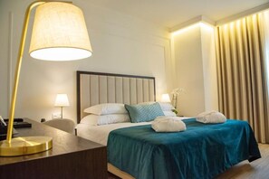 Restful retreat with a neatly made bed and a stylish floor lamp.