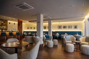 Relax in our stylish lobby, featuring comfortable seating areas and a bar with a selection of drinks.