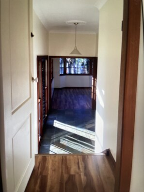 Enter a serene bedroom with a large window and a comfortable bed.