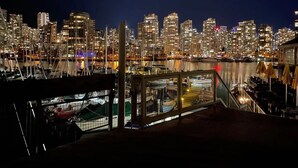 A nighttime cityscape with a marina and buildings. - Vancouver Waterfront 1480SF 2BR Townhome with Deck at Heather Civic Marina (Vancouver)
