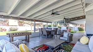 An outdoor patio with a pool table, seating area, and string lights. - Nintendo Super Mario Bros Castle in Scottsdale  (Scottsdale)