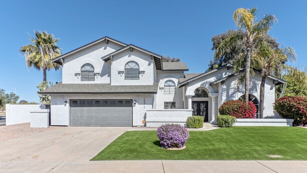 A two-story house with a garage, a well-maintained lawn, and palm trees. - Nintendo Super Mario Bros Castle in Scottsdale  (Scottsdale)