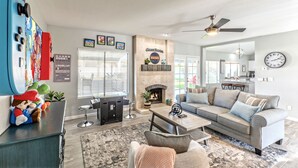 A modern living room with a fireplace, a gaming console, and a cozy seating area. - Nintendo Super Mario Bros Castle in Scottsdale  (Scottsdale)