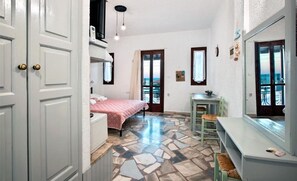 A bedroom with a bed, a desk, a chair, a window, and a door. - Studio With sea View, Creta, Ierapetra (Ierapetra)