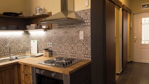 A kitchen with a stove, sink, and various kitchen items. - New - Walnuttree Double 12 Person Apartment Central in Budapest - Hungary (Budapest)