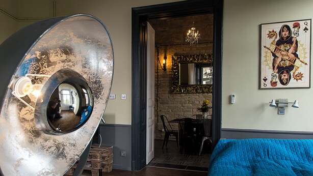 A room with a large mirror, a blue bed, and a painting on the wall. - New - Walnuttree Double 12 Person Apartment Central in Budapest - Hungary (Budapest)