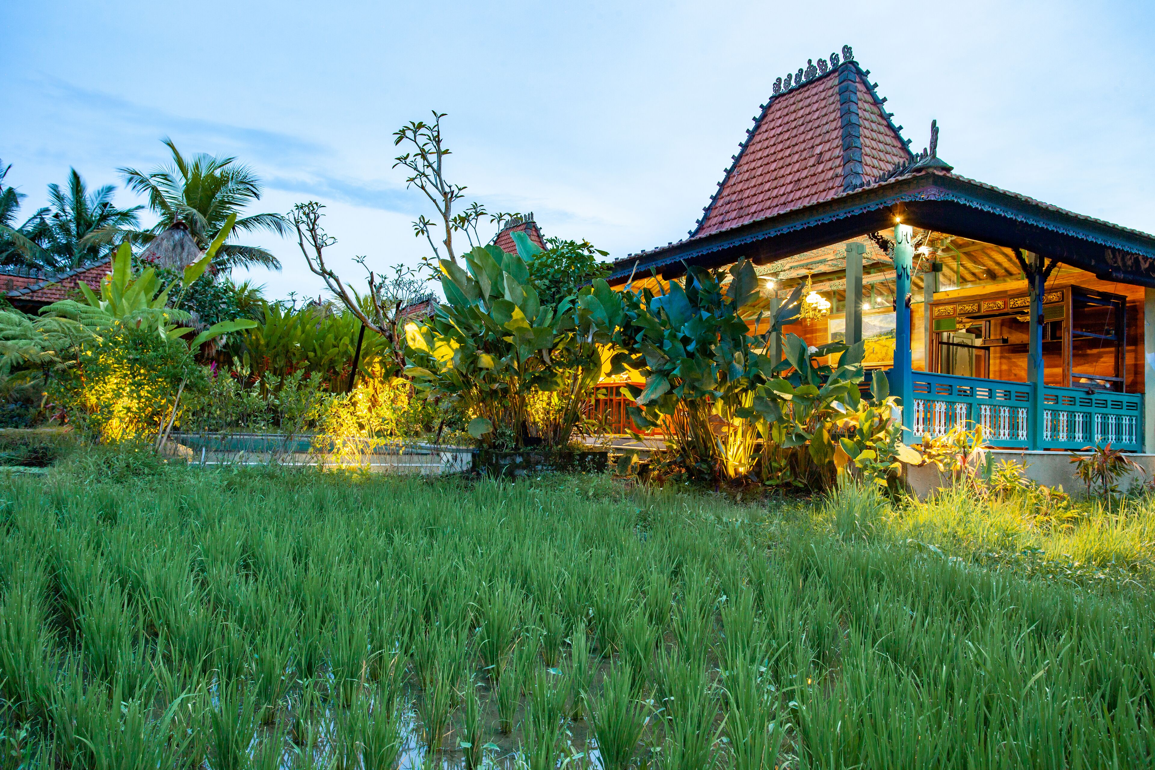 A traditional house with a tiled roof and a blue porch.