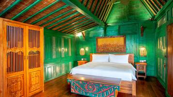A room with a wooden bed, green walls, and a wooden ceiling.
