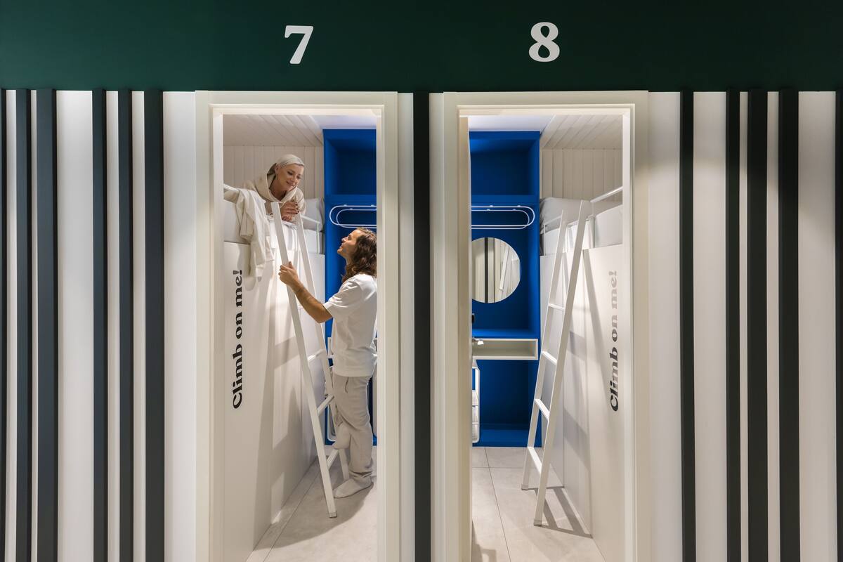 Two rooms with a white and blue color scheme, each with a ladder and a circular window.