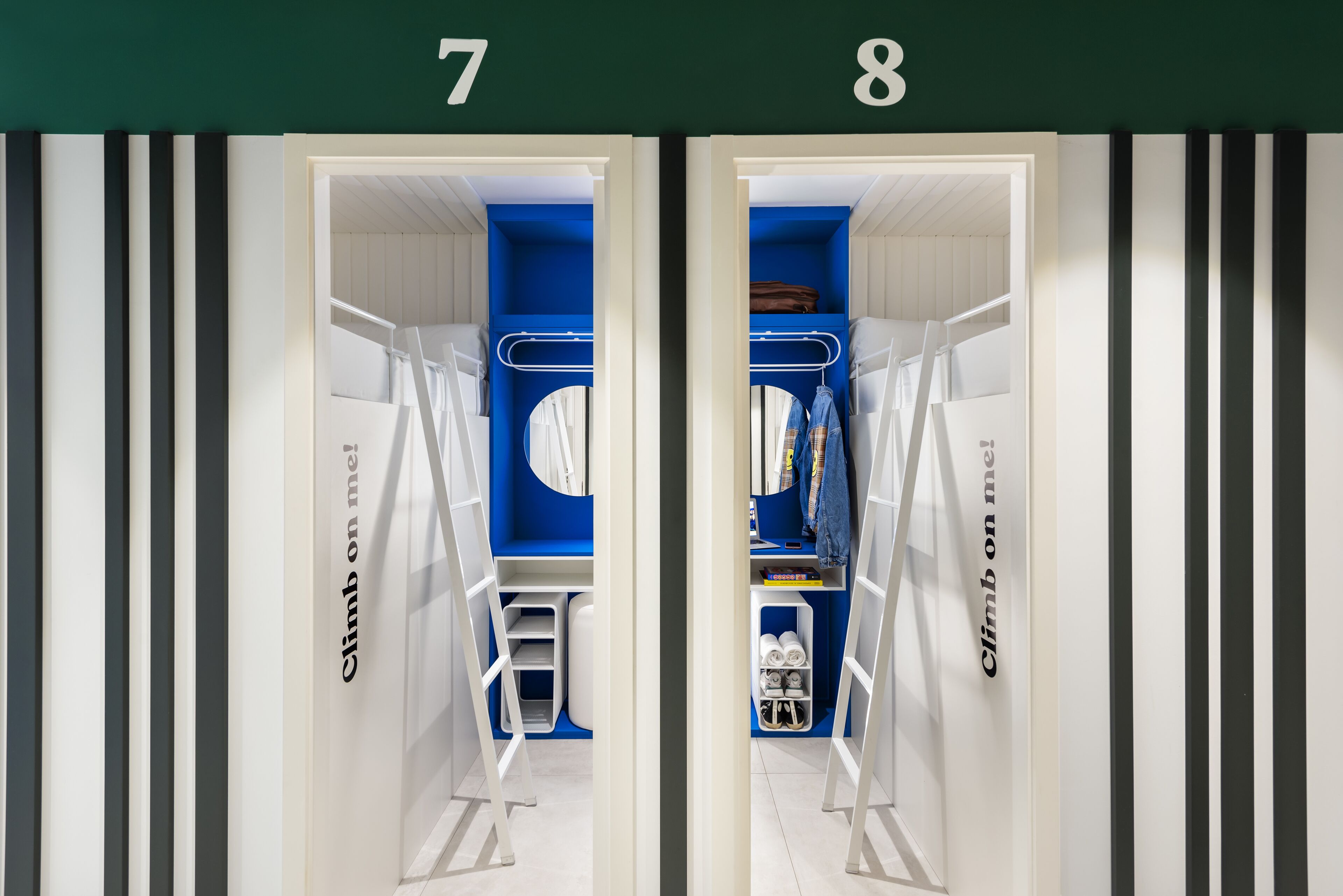 Two mirrored closet interiors with blue shelving, white storage bins, and a ladder.