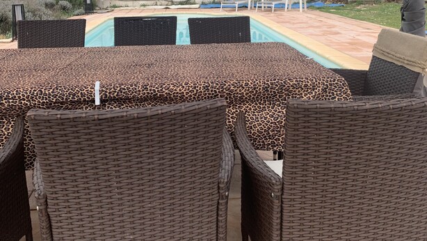An outdoor patio area with wicker furniture and a pool. - SPACIOUS APARTMENT CLOSE TO ALL AMENITIES (CONTES)