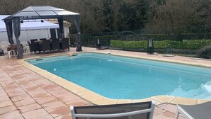 A swimming pool with a pergola and lounge chairs. - SPACIOUS APARTMENT CLOSE TO ALL AMENITIES (CONTES)