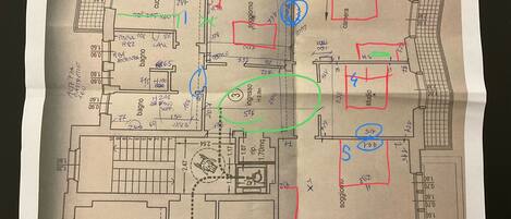 A floor plan of a hotel with labeled rooms and amenities such as a kitchen, bathroom, and entrance.