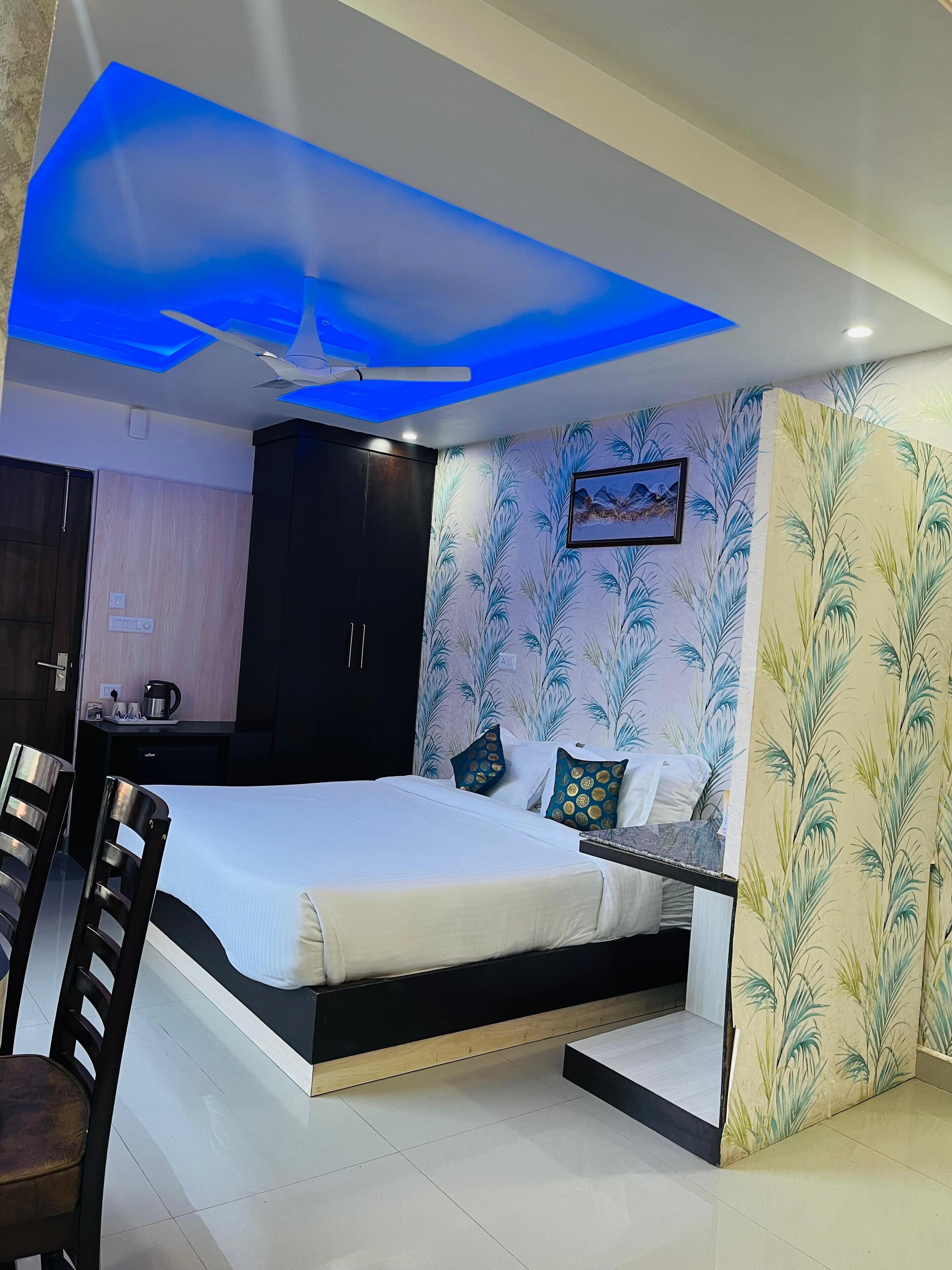 A modern bedroom with a bed, a desk, and a chair.