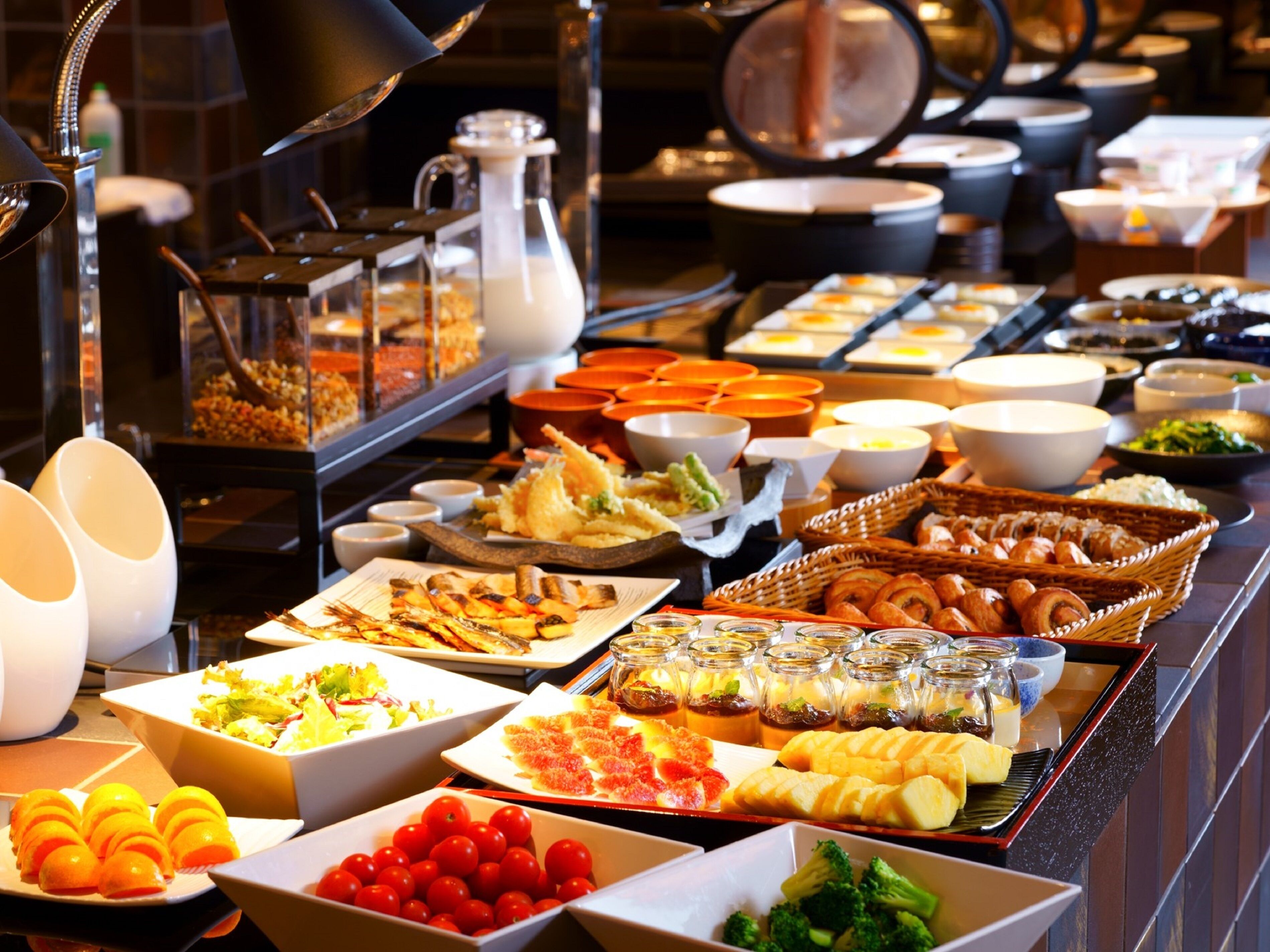 A buffet with various food items and beverages.