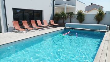 Een buitenzwembad en een verwarmd zwembad