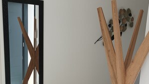 A room with a large mirror, a wooden art piece, and a wall-mounted decorative item. - Single-storey house Royan 8 pers - Heated swimming pool in summer - Pontaillac beach (VAUX SUR MER)