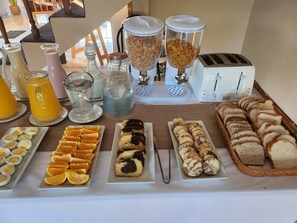 A breakfast buffet with various food items and beverages.