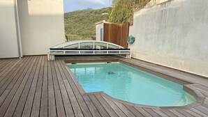 A wooden deck with a swimming pool, a wooden bridge, and a view of a hillside. - Villa Propriano 6 to 8 people VILLA WITH POOL AND SEA VIEW (VIGGIANELLO)