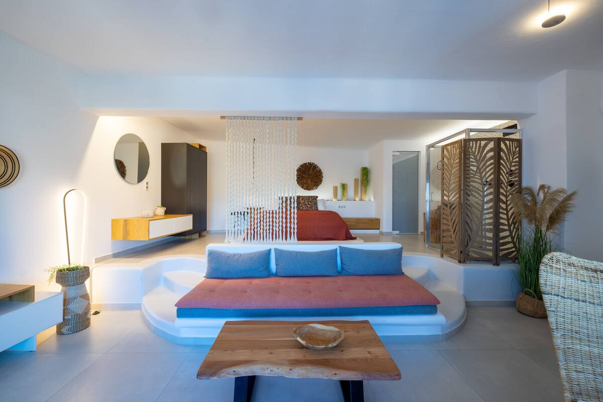 A modern living room with a sofa, a wooden coffee table, and a decorative wall piece.